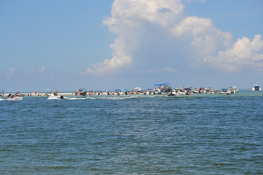 Party on the Pass Organizer Rick Schineller estimates at least 100 boats and watercraft were docked at the Big Pass sandbar.
