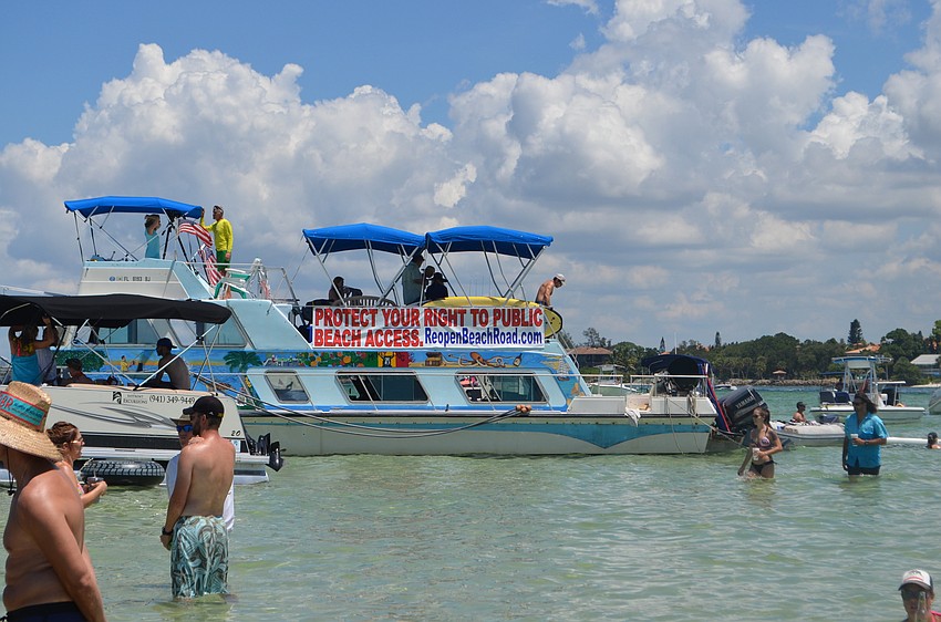 Siesta Key resident Mike Cosentino docked his boat advertising his initiative to reopen a portion of Beach Road.