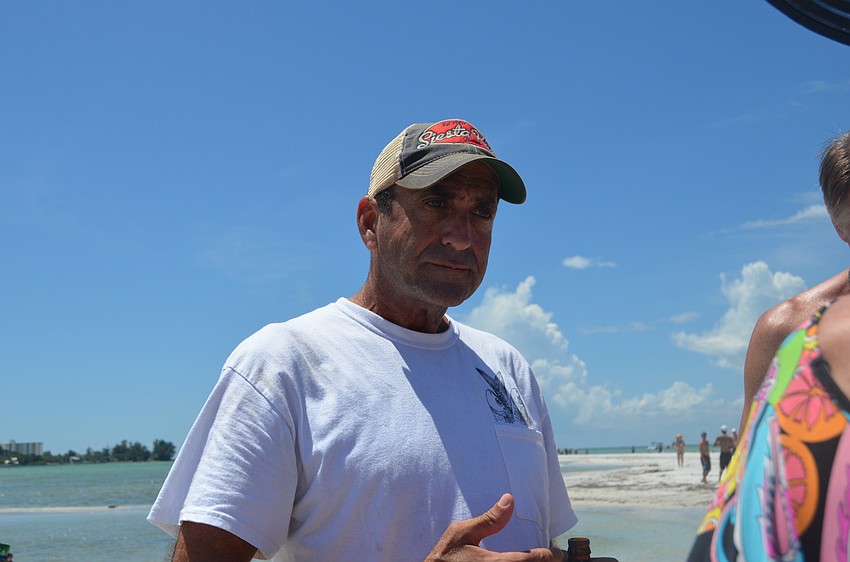 Mike Cosentino explains to Party on the Pass attendees the process for reopening a portion of Beach Road on Siesta Key.