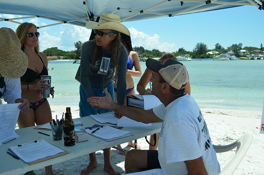 Mike Cosentino asks Party on the Pass attendees to consider signing the charter amendment petition to reopen a portion of Beach Road on Siesta Key.