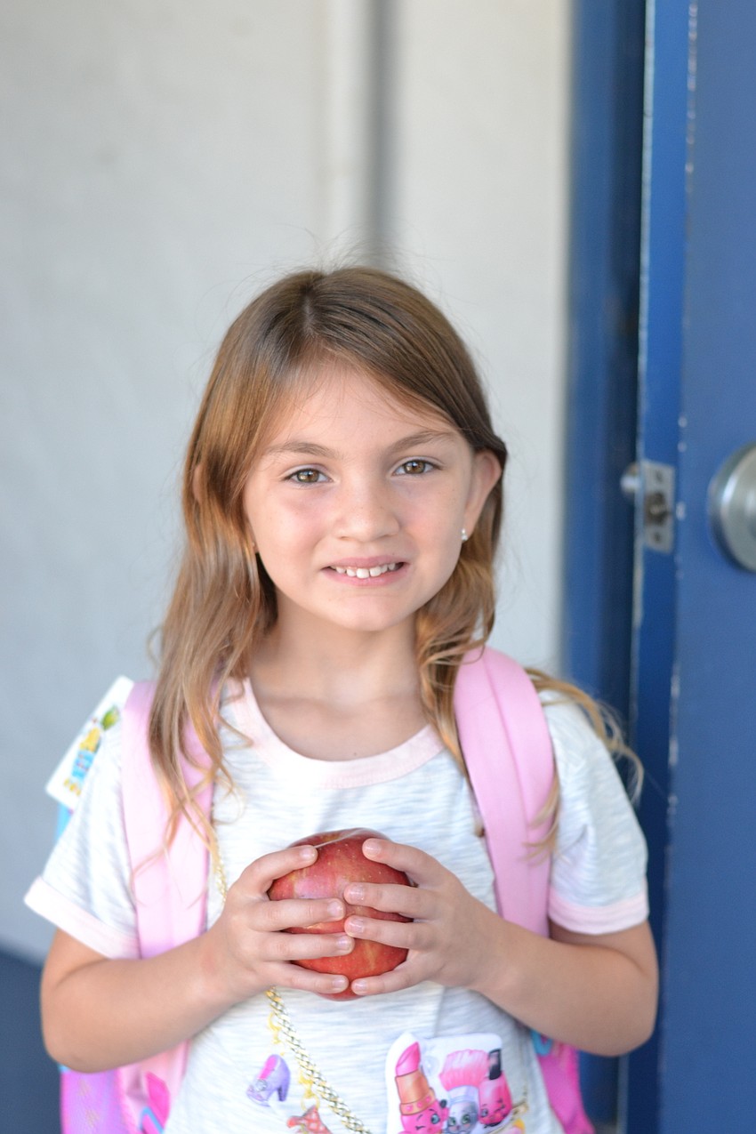 Kindergarten student Alexandra Rains brought an apple for her new teacher.