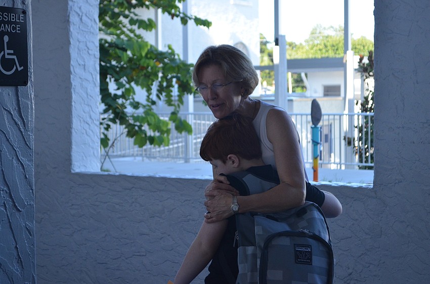Speech and language teacher Kathy Gold welcomes students to campus at Bay Haven School of Basics Plus.