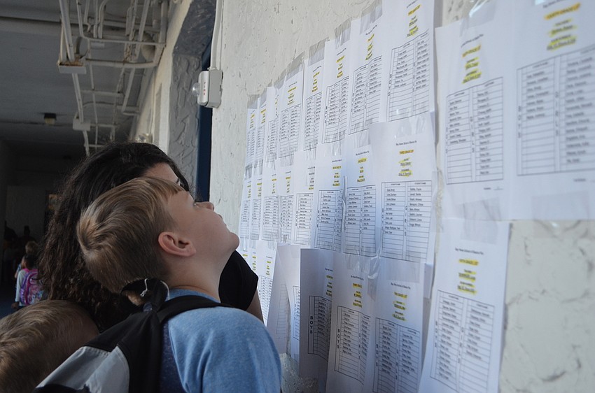 Students look up class schedules in the halls of Bay Haven School of Basics Plus.