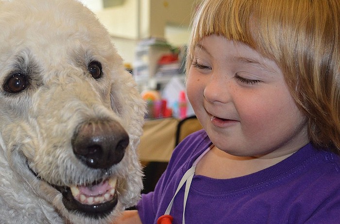 The Haven preschool client Rebekah Ithier gets a kiss from Goose Godby. Courtesy image.