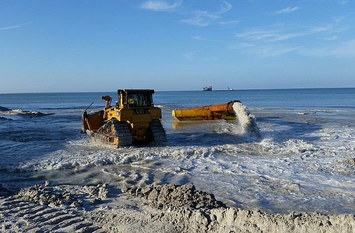 Sand dredging begins to establish a beachhead from which to work using sand dredged from in New Pass.