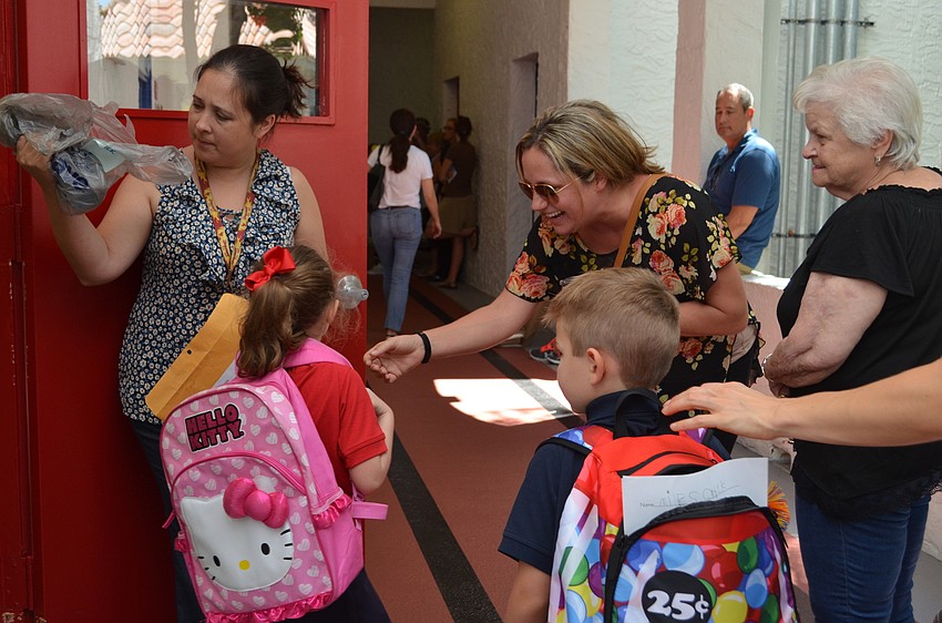 Taylor Wick runs to greet her mother Jennifer after her first day of school.
