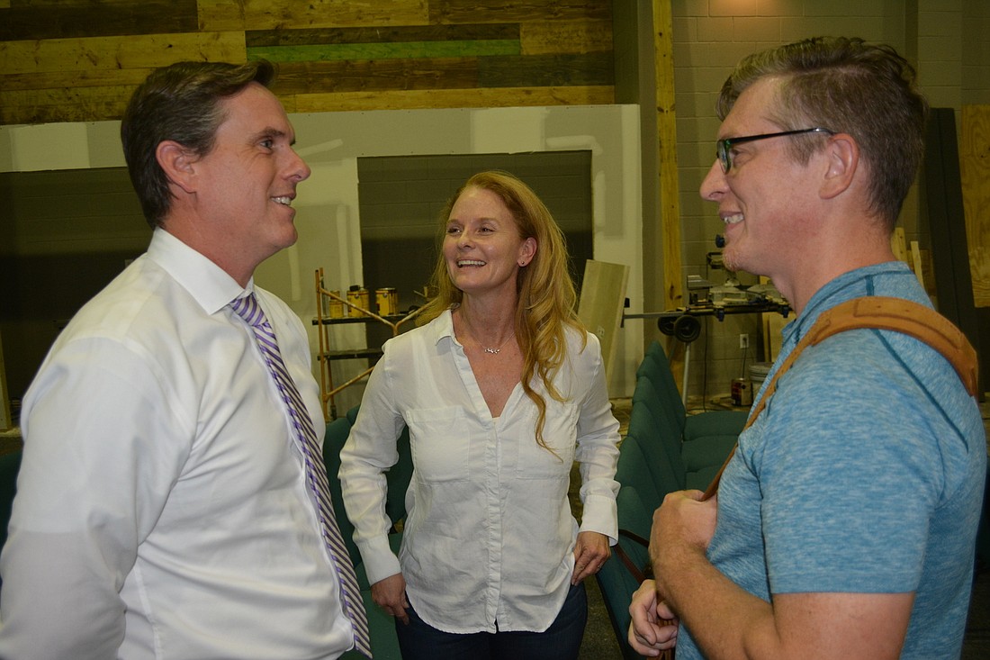 Attorney Kevin Richard Bruning talks with Heather and Terry Mitchell after a special meeting of the Mill Creek HOA.