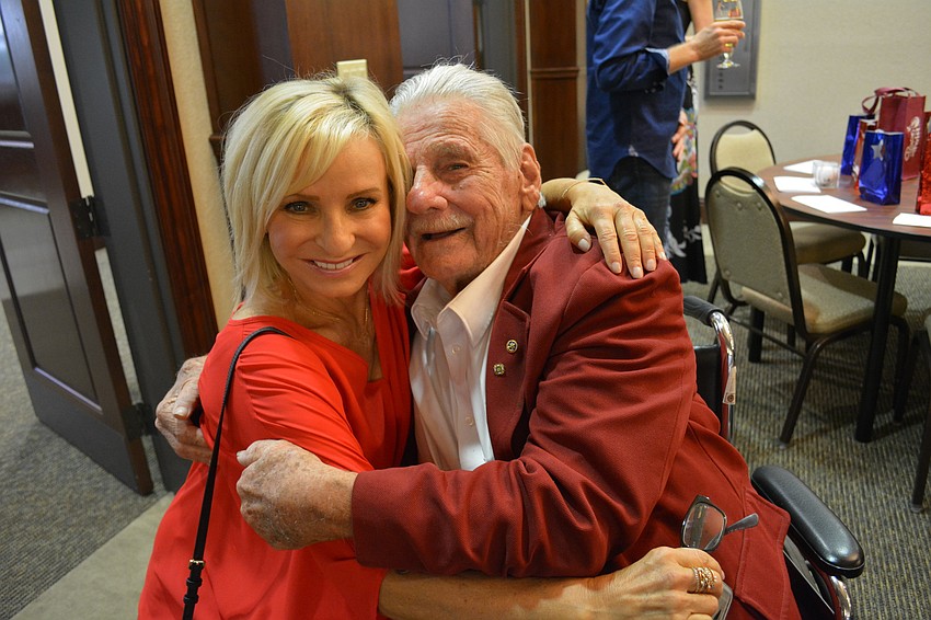Lulu Soeder of 92.1 CTQ hugs Capt. Bob O'Neil, a Pearl Harbor survivor.