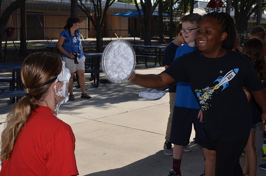 Trinity McDuffie throws a pie at Hayley Rio.