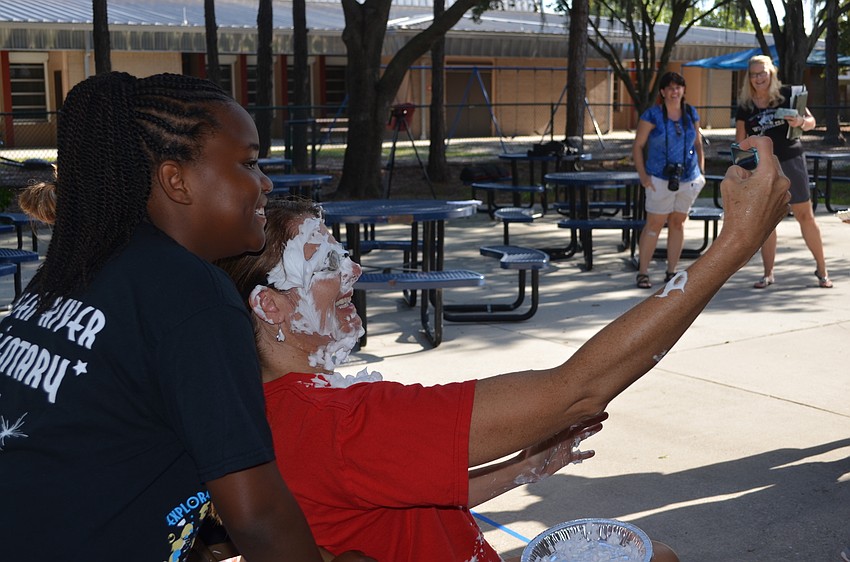 Trinity McDuffie takes a selfie with Hayley Rio after she throws pie at her face.