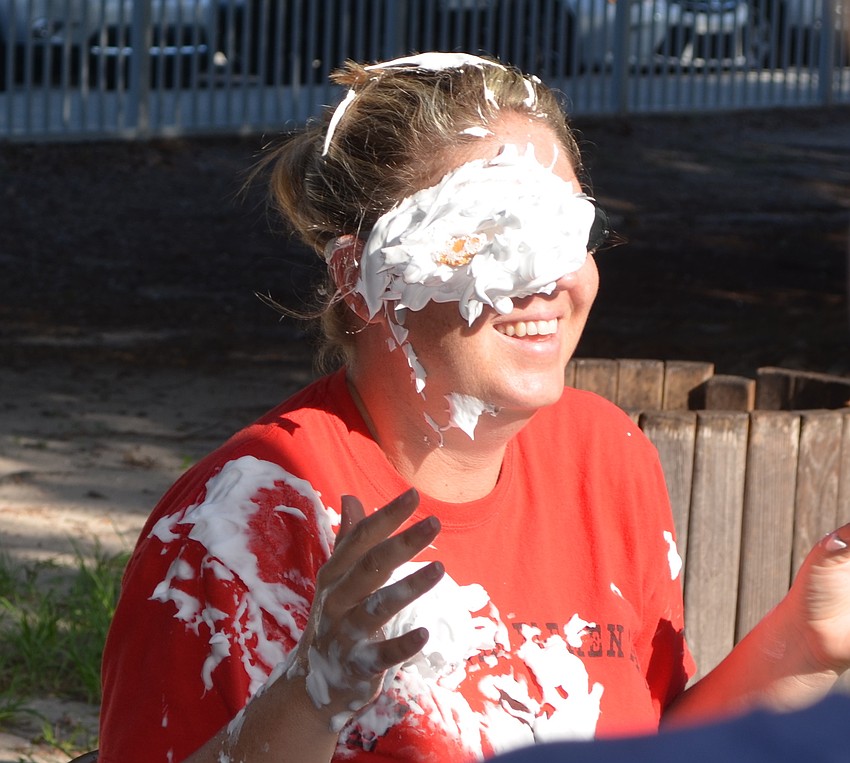 Assistant Principal Christa Francis gets hit in the face with a pie.