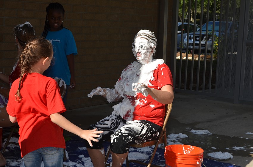 Lily Harris throws a pie at Assistant Principal Christa Francis.