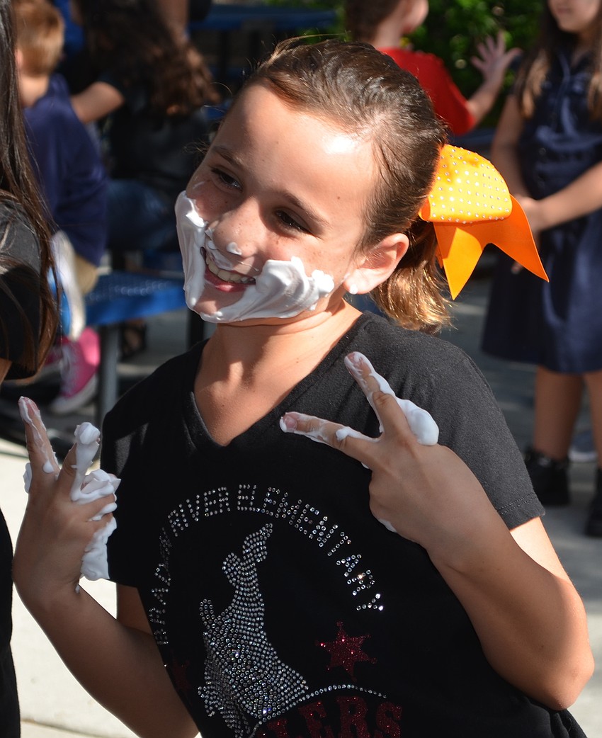 Carolyn Fincher poses with shaving cream on her face and hands.