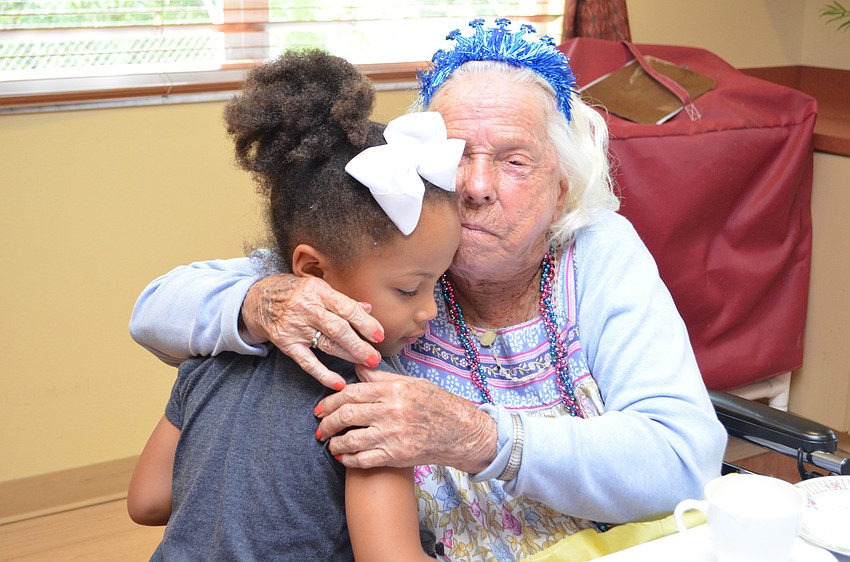 Helen Callahan receives a hug from one of the children from the on-campus daycare.
