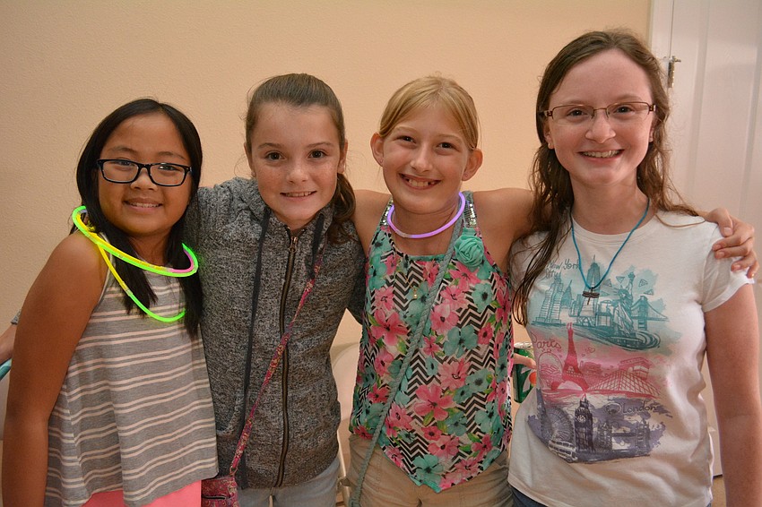 Haile Middle School students Mia Hidalgo, Kiley Kaliher and Lily Kehres hang out with Tamara Lawter, a home-school student.