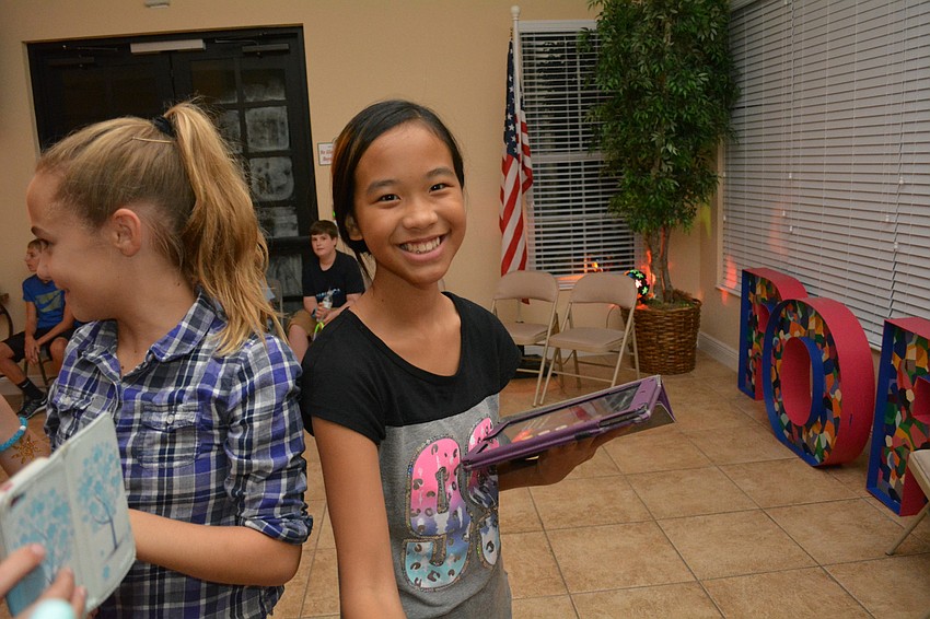 Nicole Chen, 11, records her friends signing karaoke.