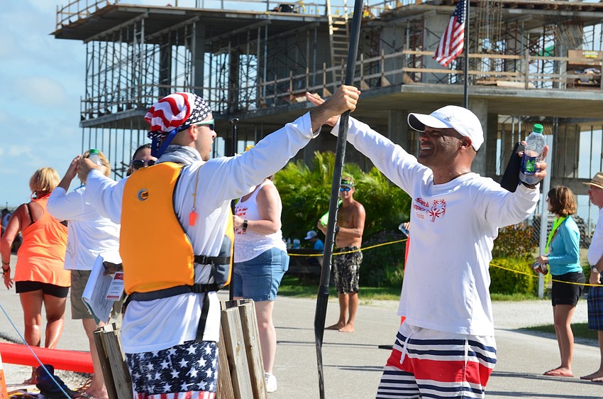 Daniel Fundora and Coach David Patlan from Miami-Dade, celebrate at the finish line.