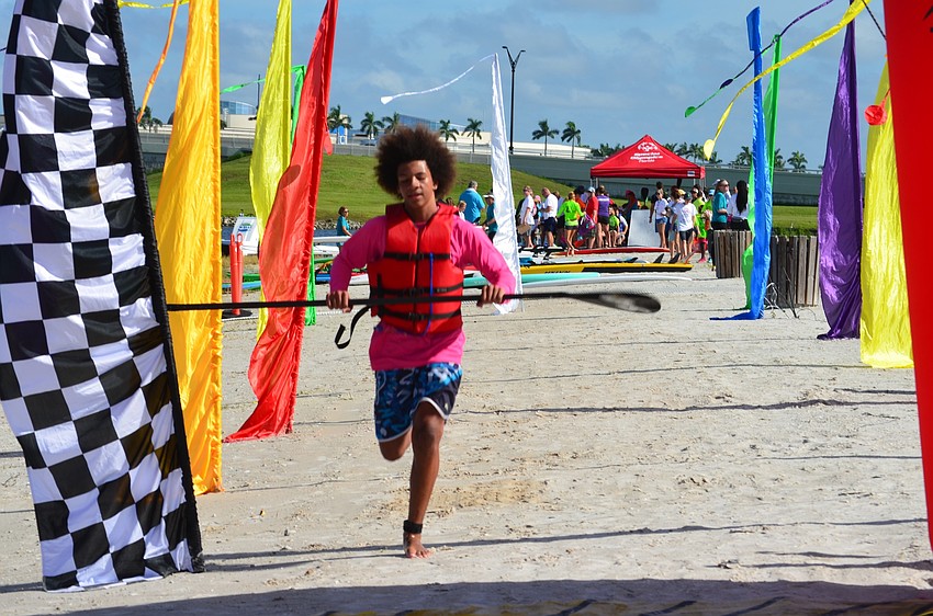 Kyle Lilley sprints, fresh out of the water, toward the finish line.