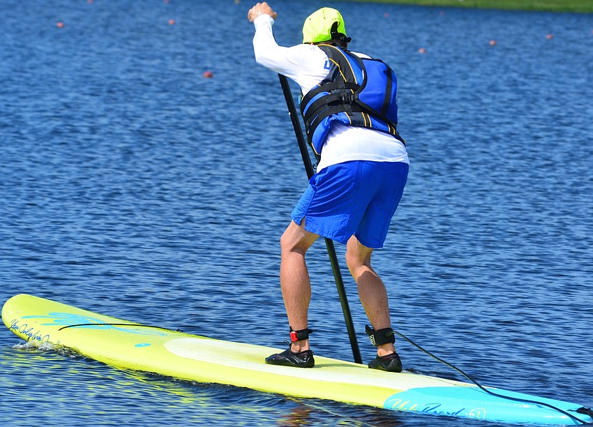 Matt Seiler stands up on his board to begin paddling.