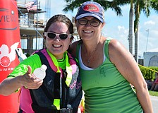 Nicki Facompre and her mom, Lynn Facompre, smile for the camera after crossing the finish line.