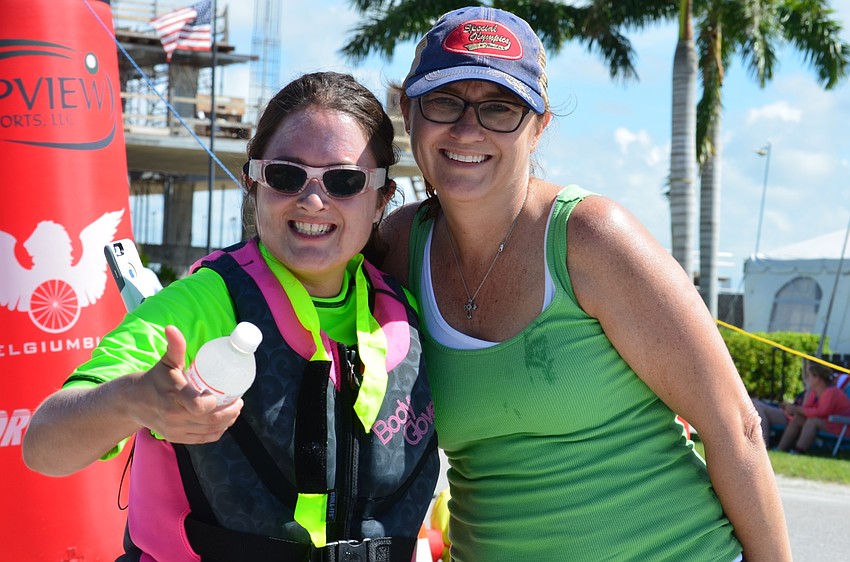 Nicki Facompre and her mom, Lynn Facompre, smile for the camera after crossing the finish line.