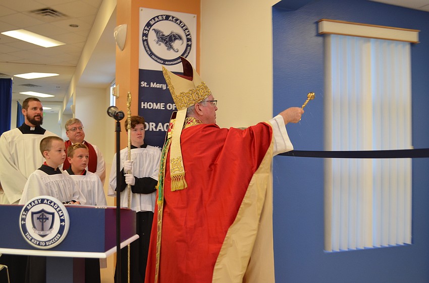 Bishop Frank Dewane blesses the the doorway to St. Mary Academy.