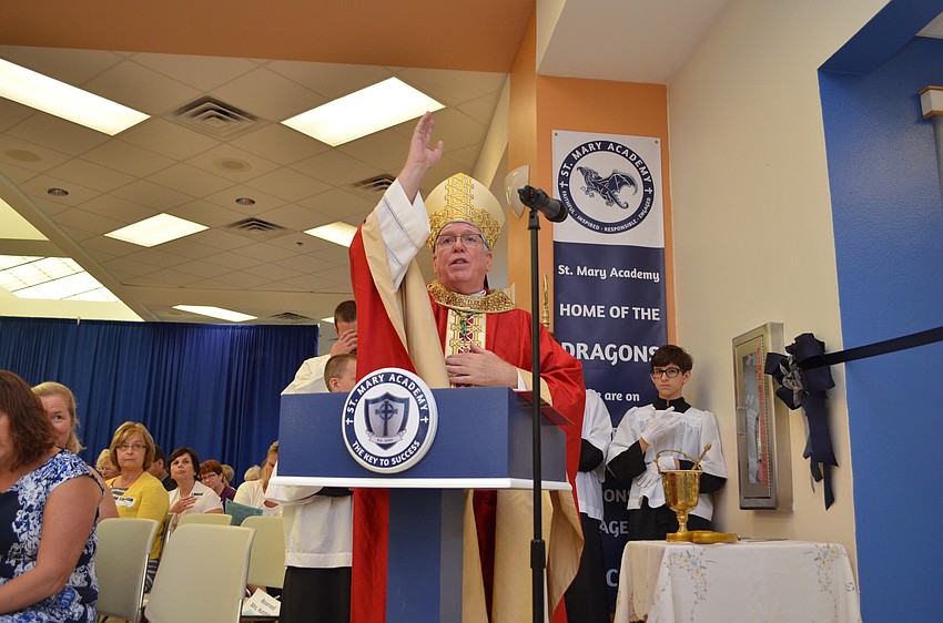 Bishop Frank Dewane leads the prayer before the ribbon cutting for the re-named St. Mary Academy.