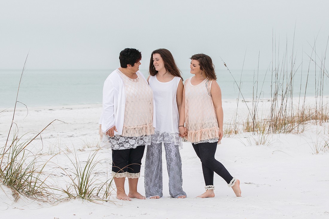 Lena Schlabach and daughters/co-workers Sydni and Felicia Schlabach take a break during their August visit to Sarasota to do a photoshoot on the beach. Photo courtesy of Katelyn Prisco Photography.