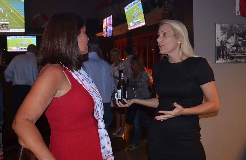 Alex Miller (right), who won her primary race against fellow Republican John Hill Tuesday night, offered Teresa Mast advice after losing the school board seat to incumbent Caroline Zucker. 