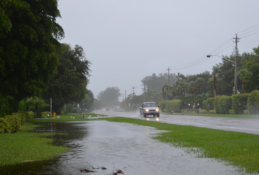 Most yards along Gulf of Mexico Drive in Longboat Key flooded Thursday.