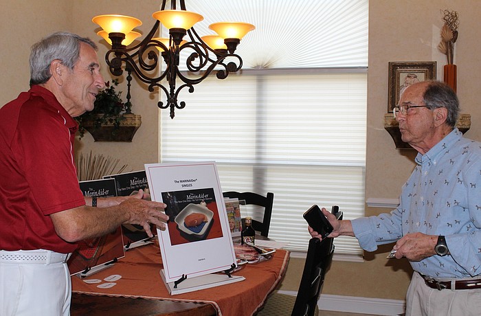 Louis Siegel, at right, practices his three-minute pitch about the MarinAid-er as Paul Halpern rotates the boards for him.