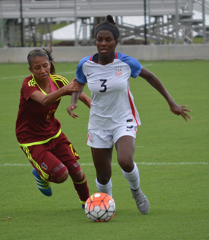 Brianna Pinto bursts past Venezuela's Heliamar Alvarado.