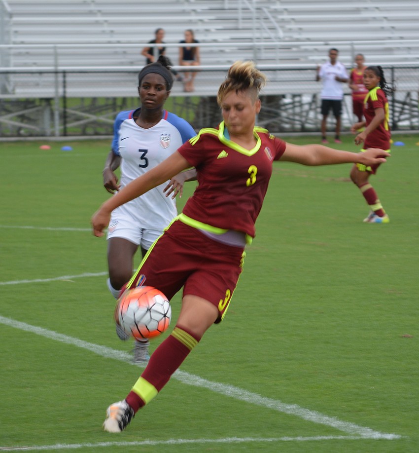 Venezuela's Sandra Luzardo gets to the ball before Brianna Pinto of the United States.