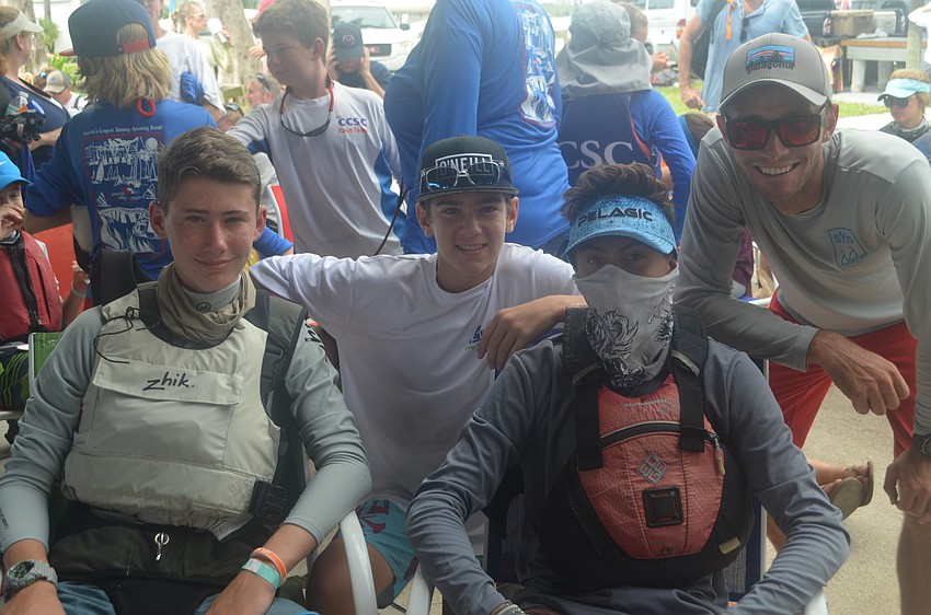 Jack Soodak, 14, Devin Wade, 13, Andrew Florio, 14, and their coach, Dalton Tebo