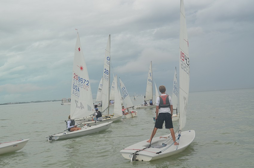 Sailors head out past the sandbar before the first horn.