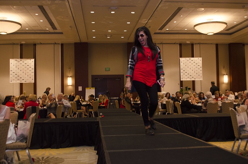 Kristy Lockhead works the runway with her cellphone as an accessory.