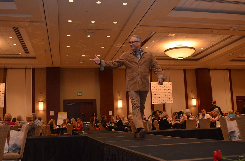 Steve Zeris acknowledges a cheering fan as he walks the runway.