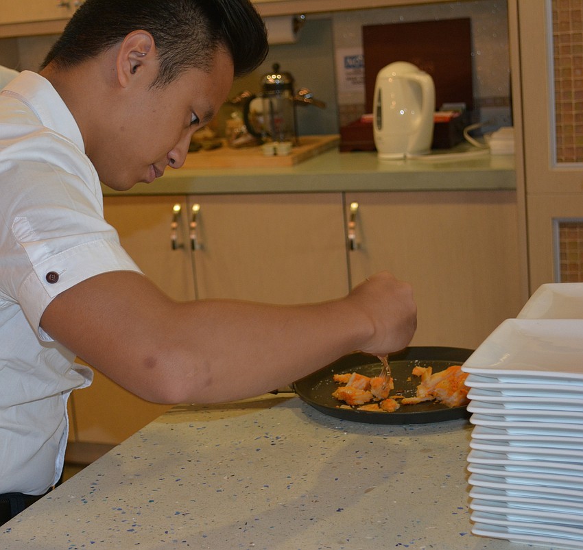 Henry Yeh, a student from Taiwan's National Kaohsiung University, Hospitality and Tourism, works during USF's 