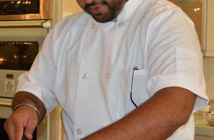 Angad Singh, a USF graduate assistant, prepares a pork tenderloin tapas for "Bulls Bistro."