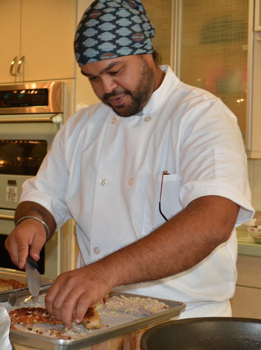 Angad Singh, a USF graduate assistant, prepares a pork tenderloin tapas for 