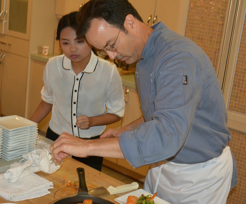 USF instructor and chef Joe Askren puts the final touches on tapas for the first 