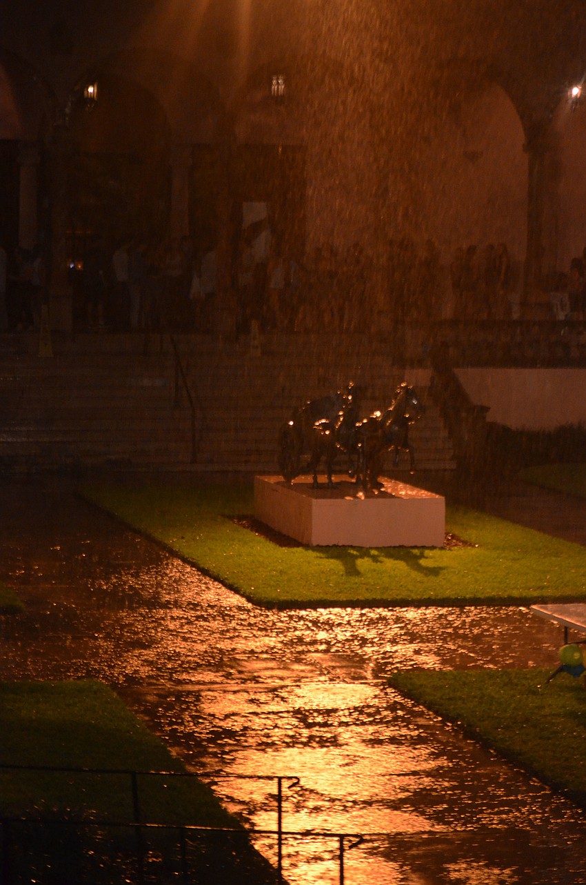 Attendees take cover from the rain after Cassolette’s performance was cut short.