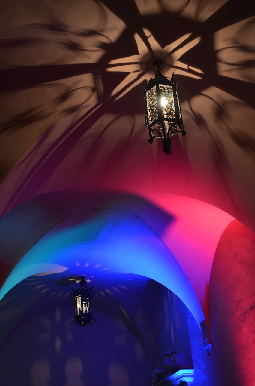 Multicolored stage lights project onto the walls and ceiling outside the museum before the performance by Soapbox Soliloquy And The Nimbus Initiative.