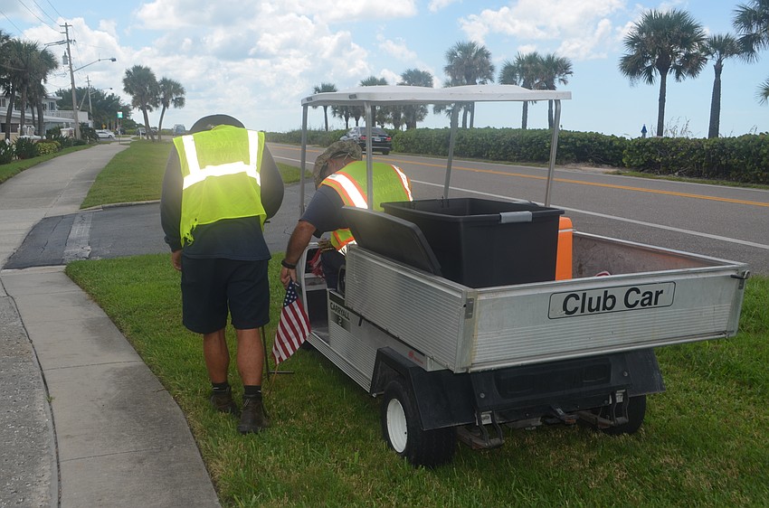 Troy Wooten and Frank Scrivani helped place 2,977 flags along GMD on Sept. 9.