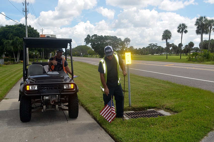 Lloyd Hine and Mike Ball travel down GMD placing American flags along their way in honor of 9/11.
