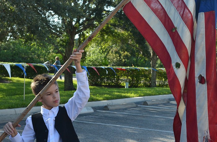 Fifth-grader Gavin Garner presents Old Glory.