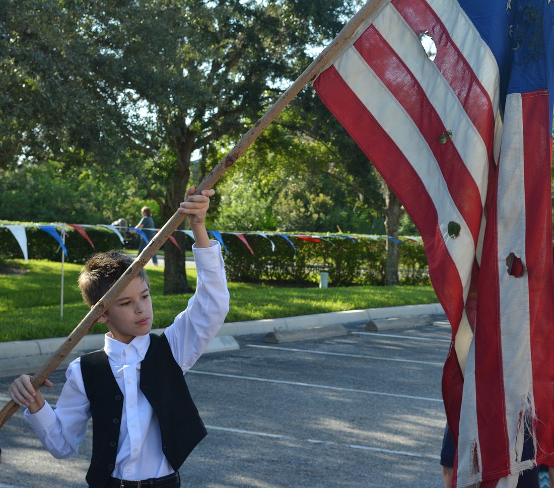 Fifth-grader Gavin Garner presents Old Glory.