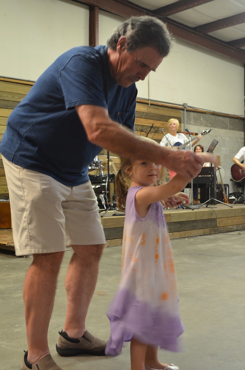 Michael Griffin dances with his granddaughter, Talia Luther.