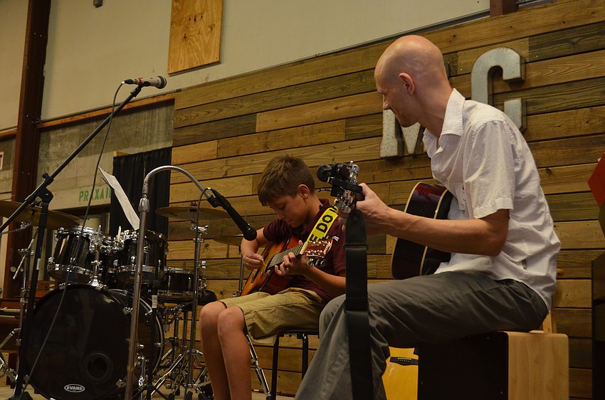 Music Compound student Trevor Griffin, 10, plays a compilation of three famous theme songs — “James Bond,” “Jaws” and “Star Wars” — with his teacher, Paul Luther.