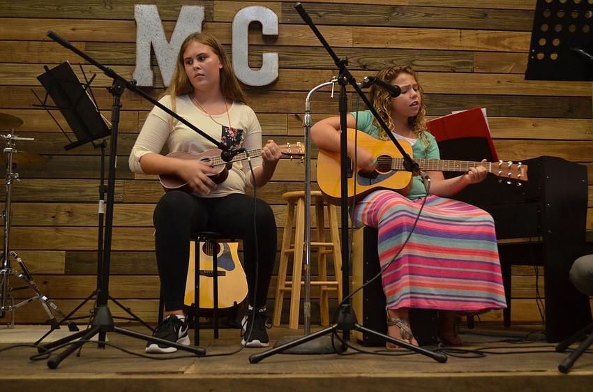 Music Compound students Sage Wanvig and McKenzie Riley perform a cover of “Wagon Wheel.”